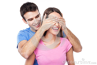 man-covering-woman-s-eyes-his-hands-38445487